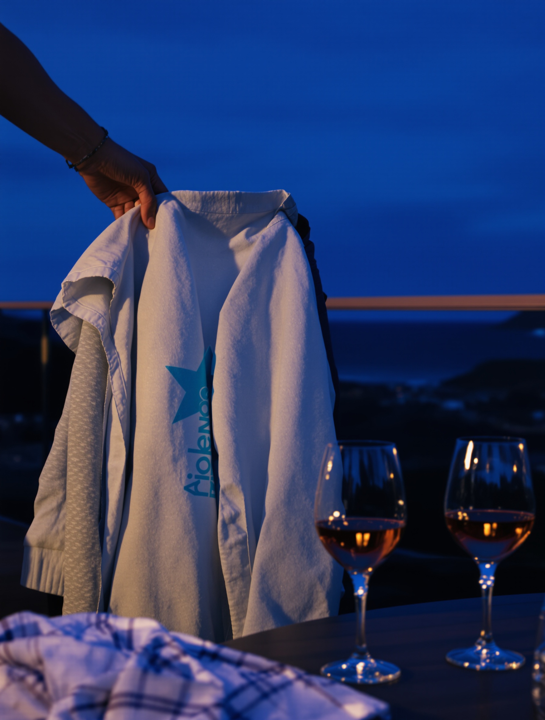 Main posant un sweat sur une chaise lors d'un apéro venté à Lanzarote.